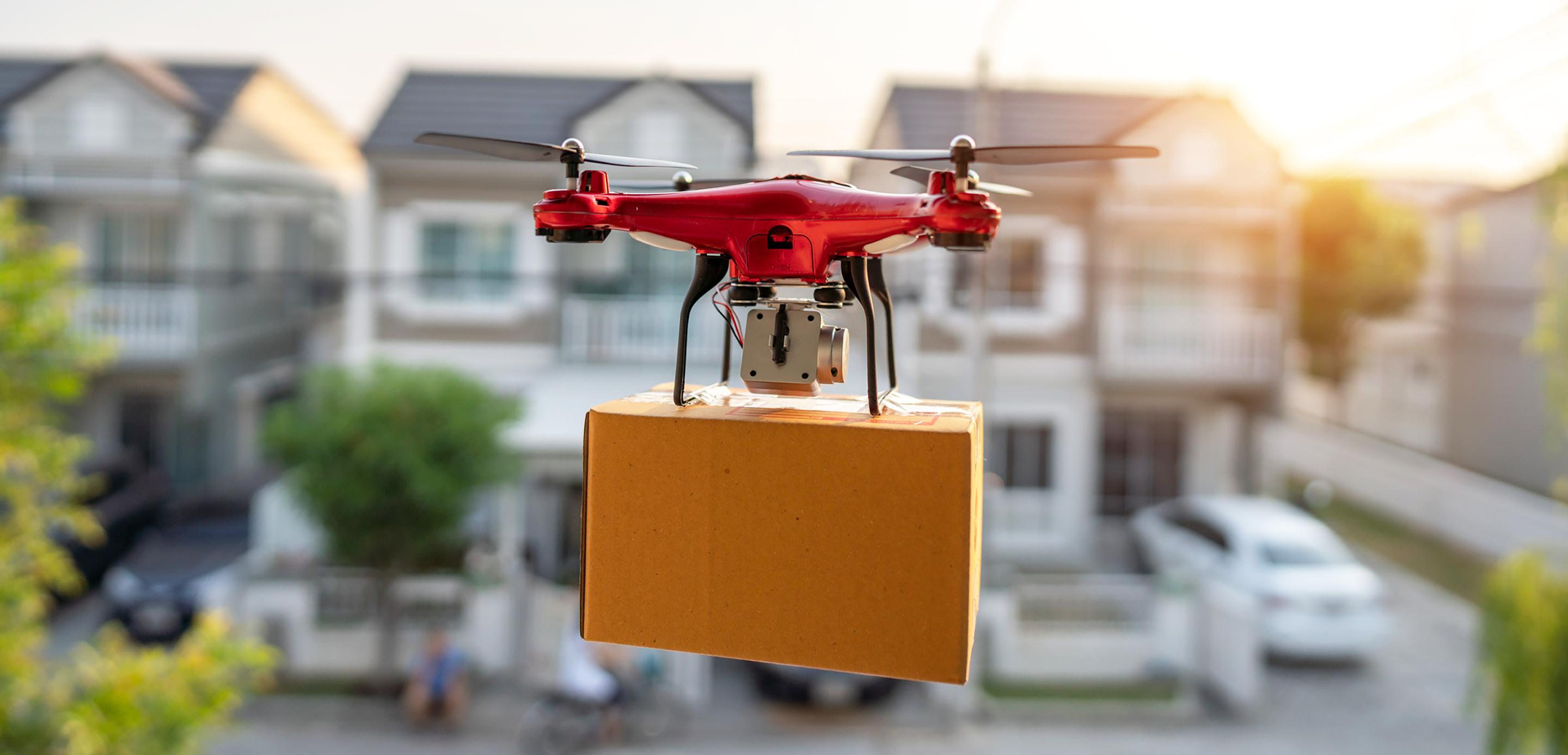 Drone delivering a parcel to a home Drone delivering a parcel to a home