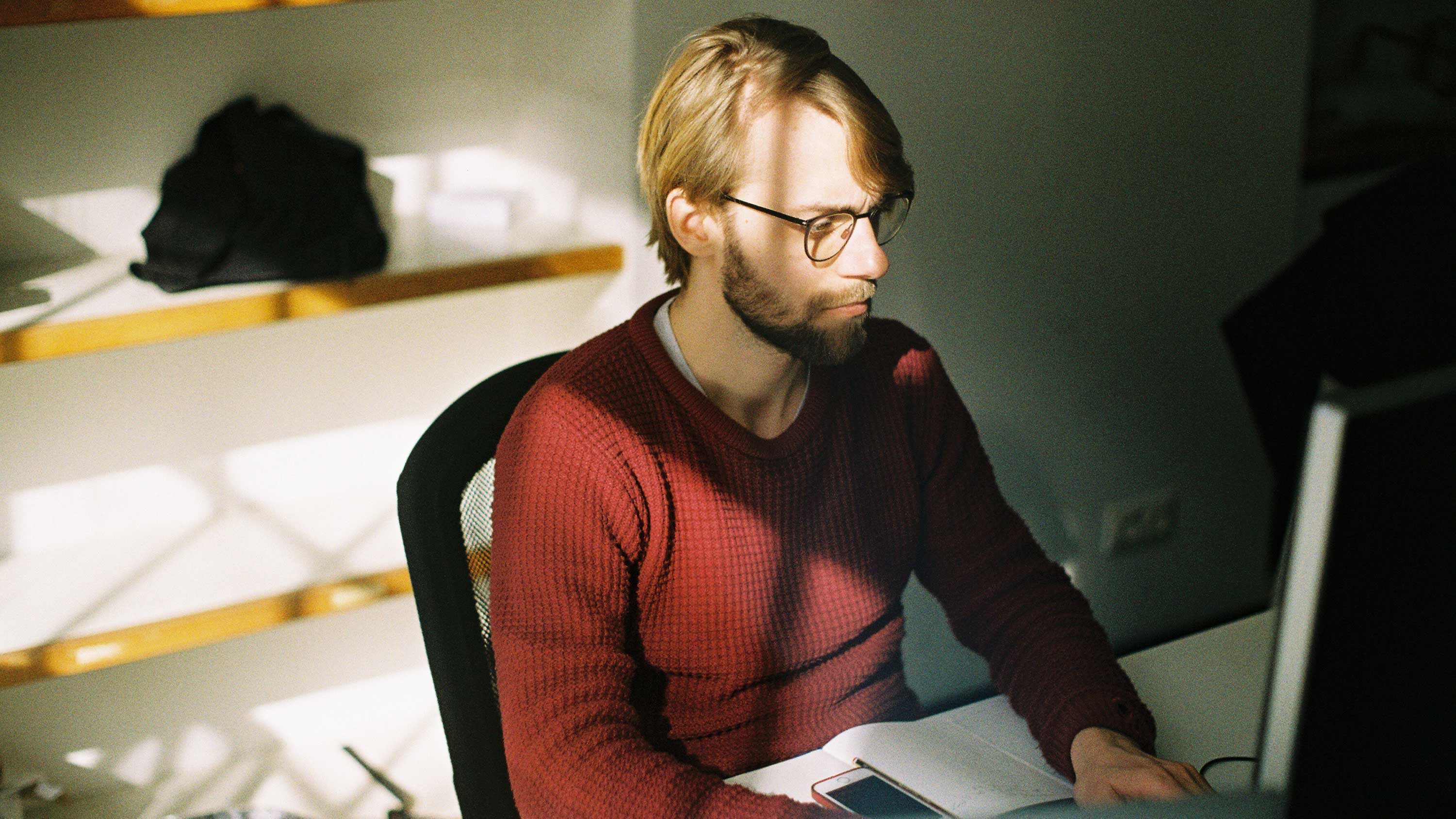 Serious looking man working at a desktop computer Serious looking man working at a desktop computer